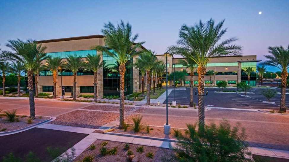 An office building with palm trees at Chandler 202 Business Park.