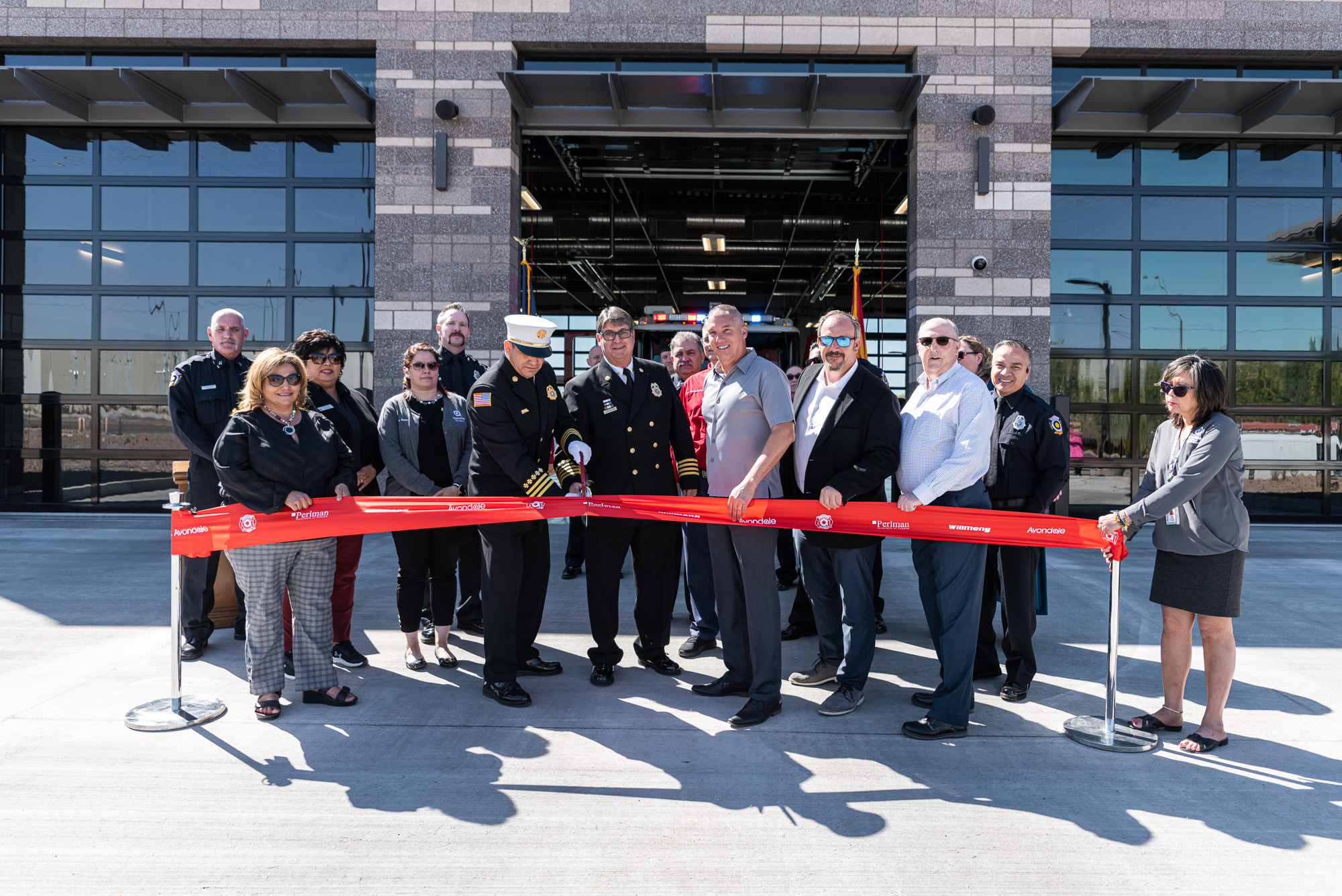Willmeng celebrates opening of Avondale Fire Station 175 with a group of people standing in front of the building and a ribbon.