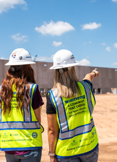 women in construction pointing