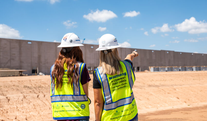 women in construction pointing