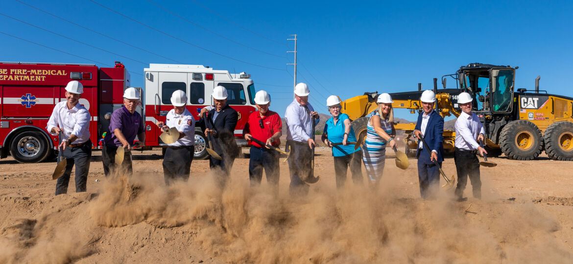 A group of people in hard hats standing in front of a shovel at the City of Surprise Municipal Complex.