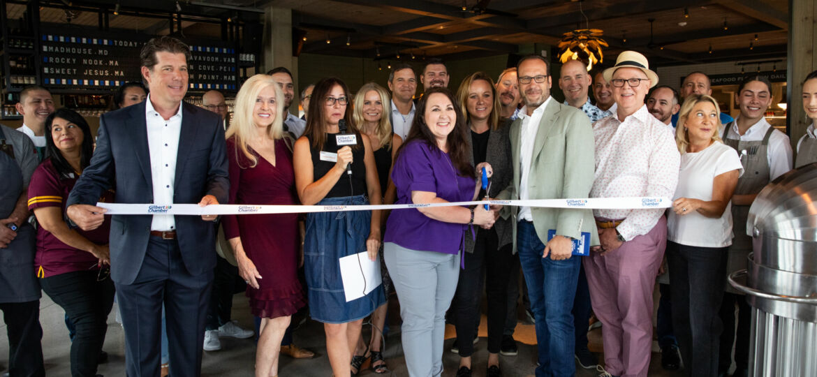 Buck & Rider at Gilbert's Epicenter hosts a group of people cutting a ribbon to inaugurate the restaurant.